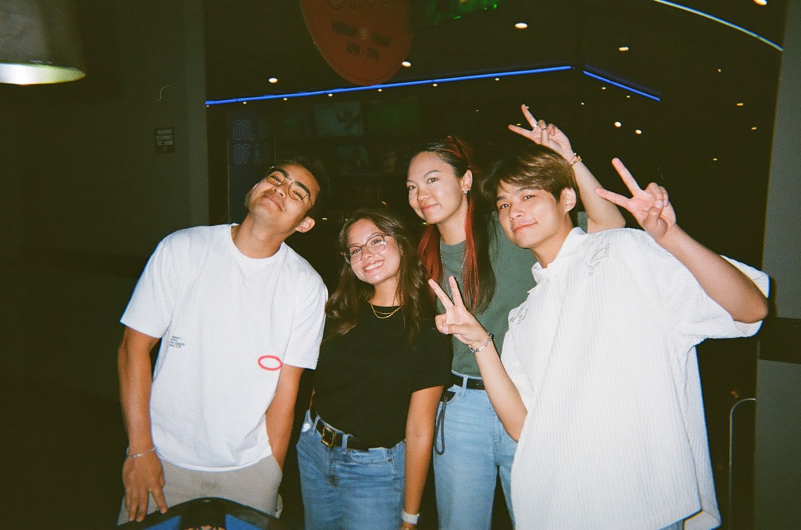 A group of young TikTok interns throwing up peace signs.